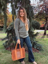 Load image into Gallery viewer, v neck long sleeve sweater paired with dark denim jeans 
