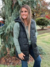 Load image into Gallery viewer, black puffer vest long with zipper closure. water and wind resistant. 
