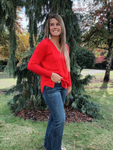 Load image into Gallery viewer, V neck sweater color red paired with denim jeans 
